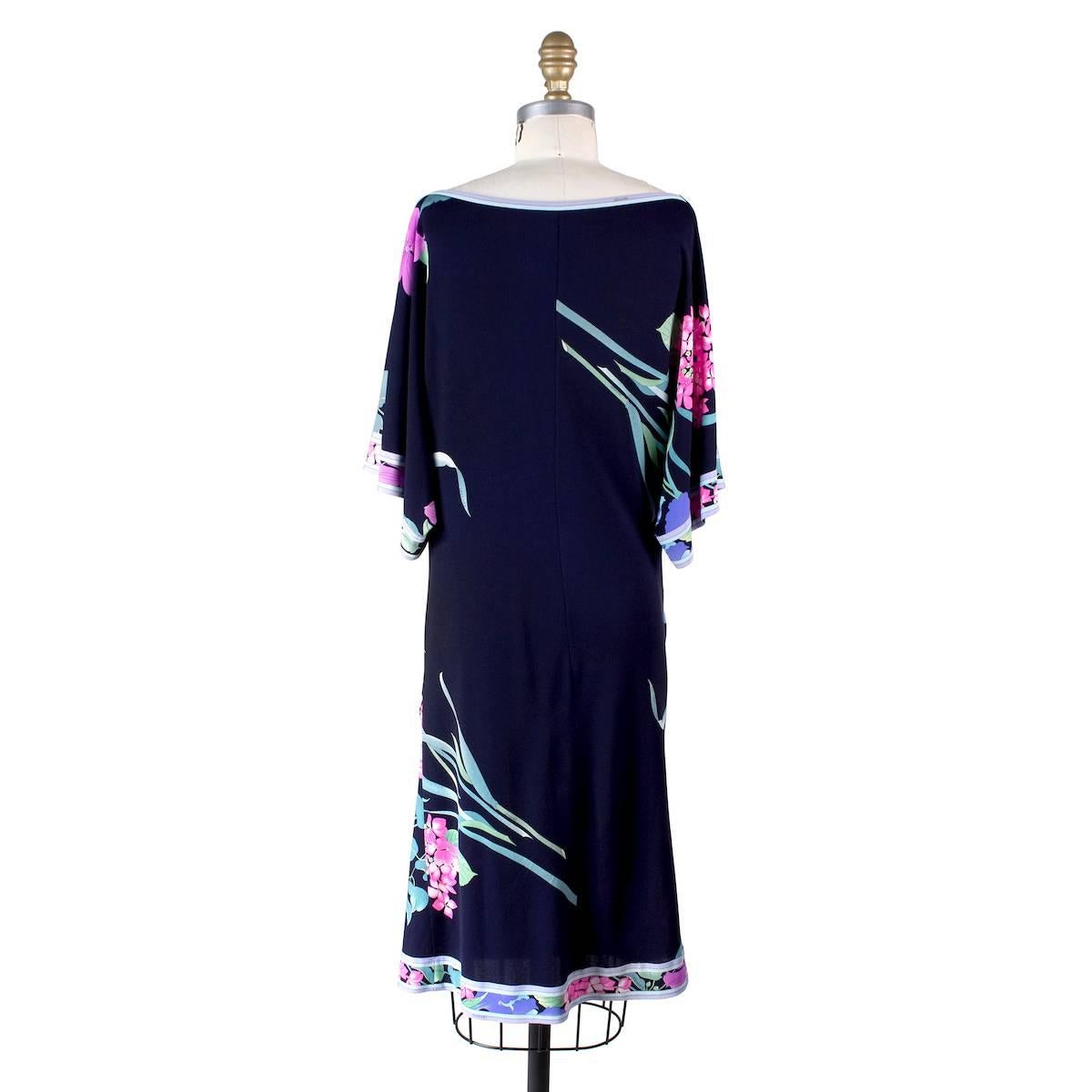 Dress from Leonard.  Made from a stretch navy silk with floral motif.  Short sleeves and subtle draping across body in front.  