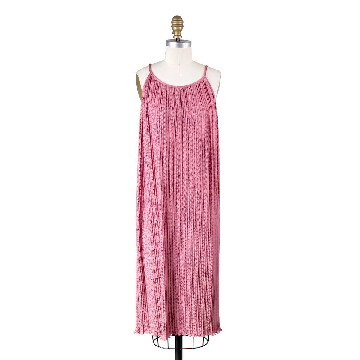 Rose pink dress by Mary McFadden.  Features crinkled texture and separate matching rope belt to tie around waist.