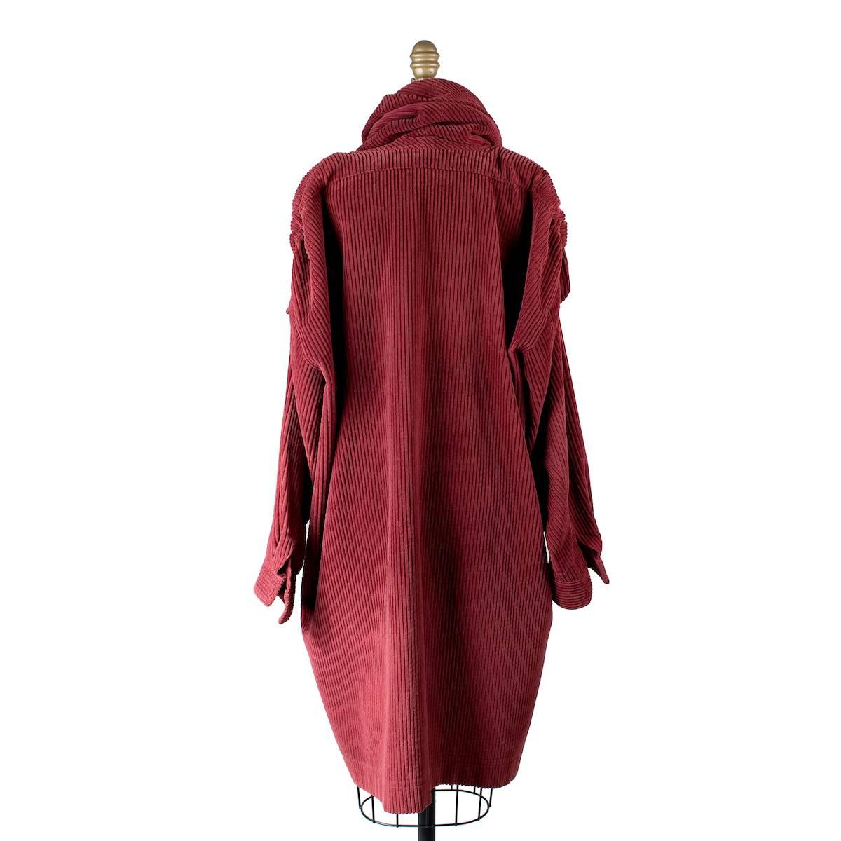 Vntage cord cloak from Kenzo.  Feaures button tab on shoulders and shawl collar.  Thick maroon colored corduroy.  