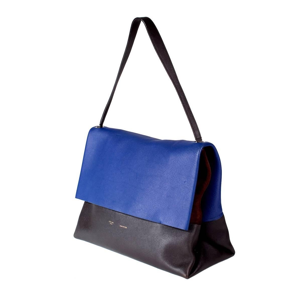 This is a shoulder bag from Celine. Tri-color leather and suede flap bag with matching pouch wallet.  

Bag dimensions:   14