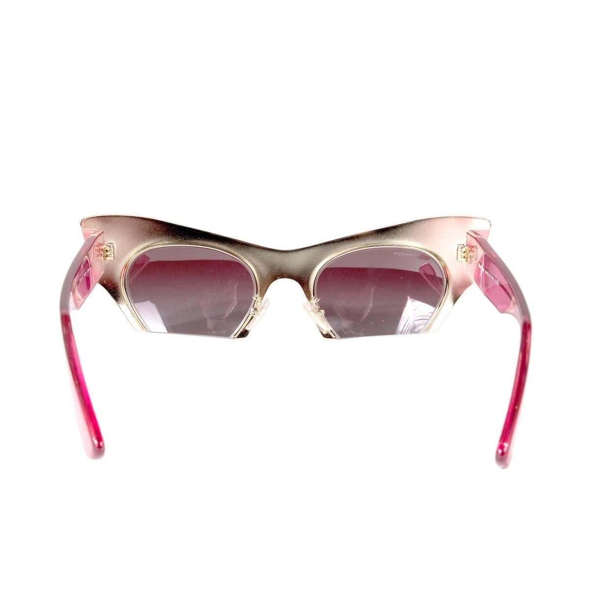 Cat eye sunglasses from Miu Miu. Pink bars with silver frame and lenses. Case included.

14.75cm frame width
4.5cm frame height
14cm bar length