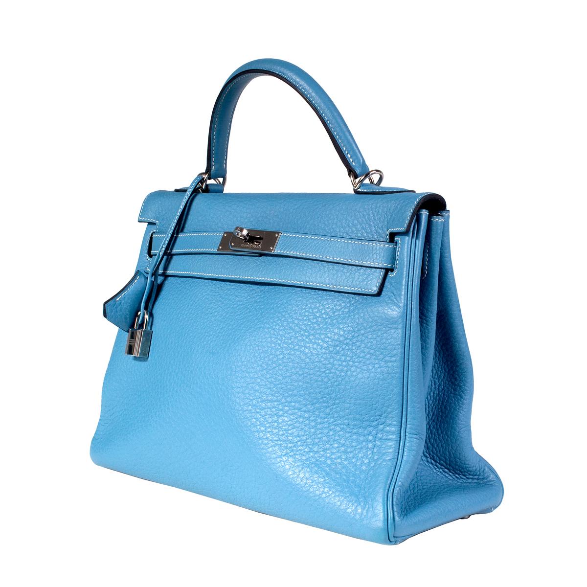 Kelly bag by Hermes from 2002
32cm size
Togo leather in blue jean color
Silver palladium hardware
Lock and key included 
Dimensions:  12.75