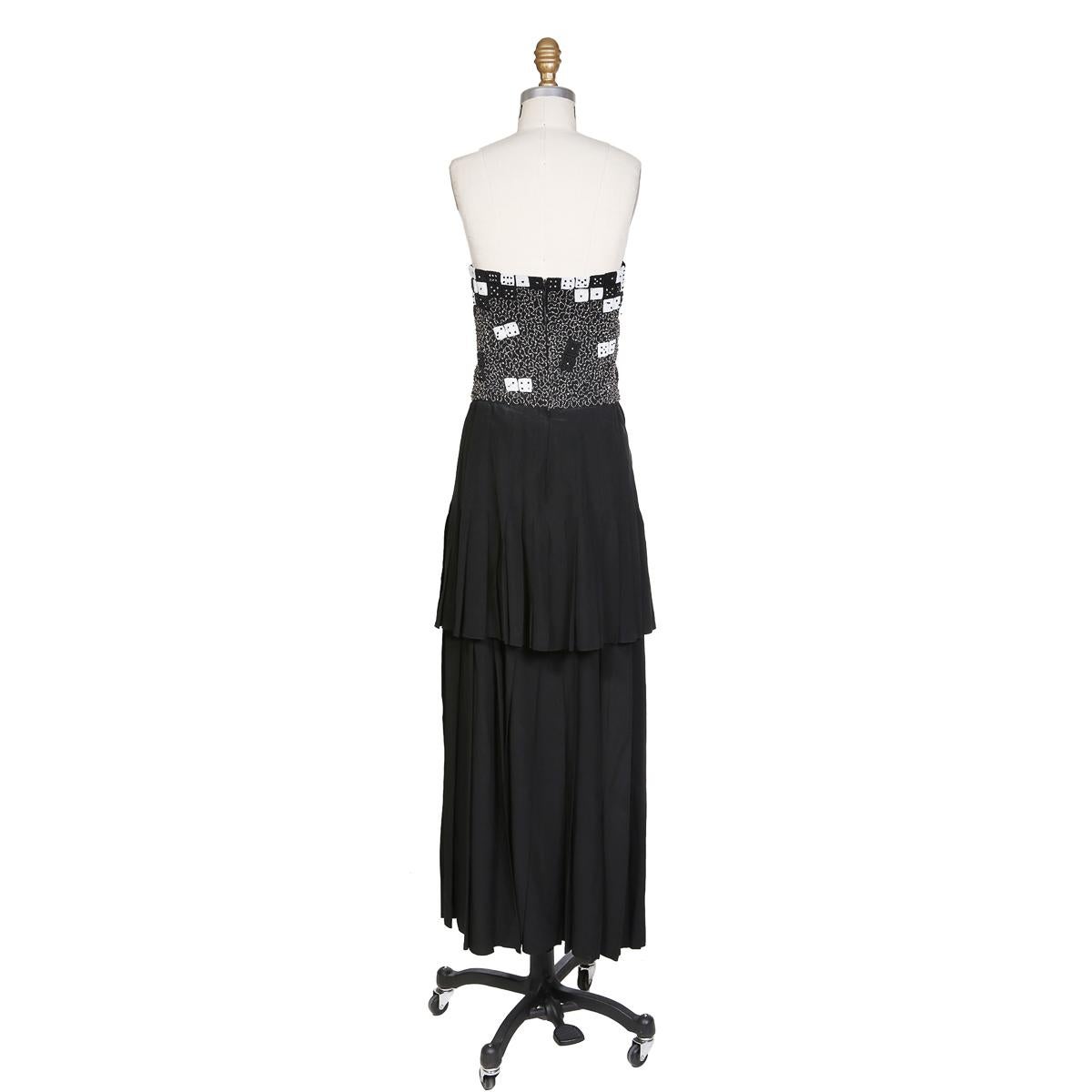 Vintage dress by Karl Lagerfeld for Chloe circa 1970s/1980s
Strapless with hidden back zipper closure
Beaded bust in dice motif
Two-tier pleated skirt
Silk
Condition: Great vintage condition, with minor wear to fabric and beading