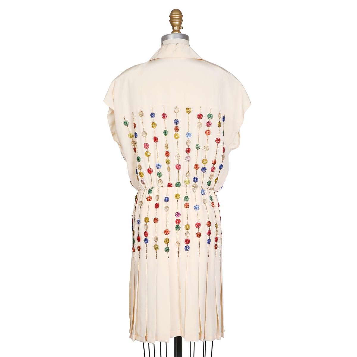 Vintage silk dress by Karl Lagerfeld for Chloe circa 1980s
Features cap sleeve and collar
Silk covered buttons closure in front
Beaded dots and lines design 
Pleating on skirt
Condition: Great vintage condition, missing tag
