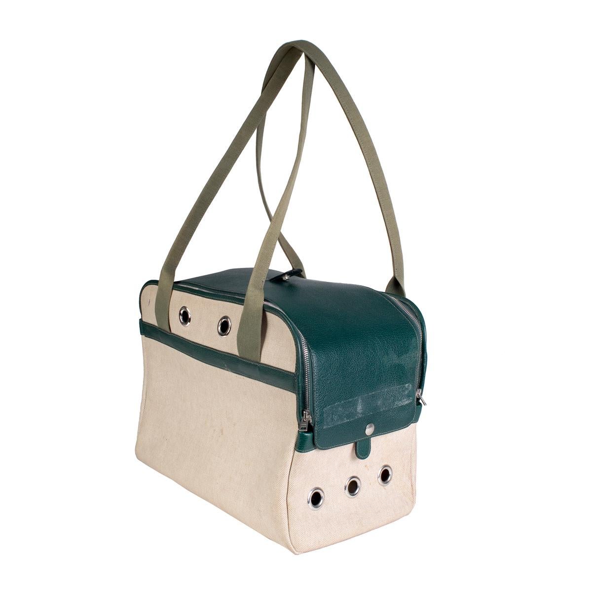 Dog carrier by Hermes
Double zipper closure on top that snaps to stay open
Large grommet holes for breathability
Green canvas web straps
Dimensions:  16
