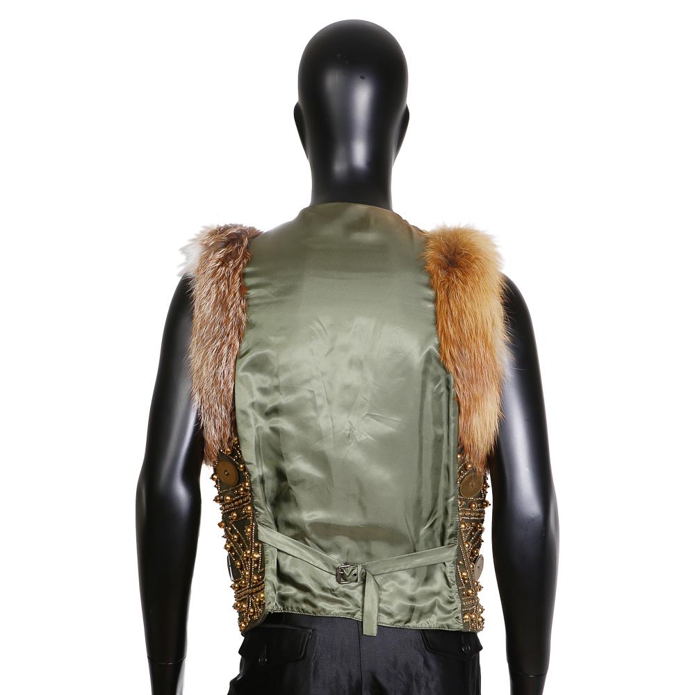 Men's vest by John Galliano, 
Military green leather 
Embellished with brass bead and paillettes
Natural fox fur trim around arms
Condition: Excellent

Size/Measurements:
Size 52 (EU)
21