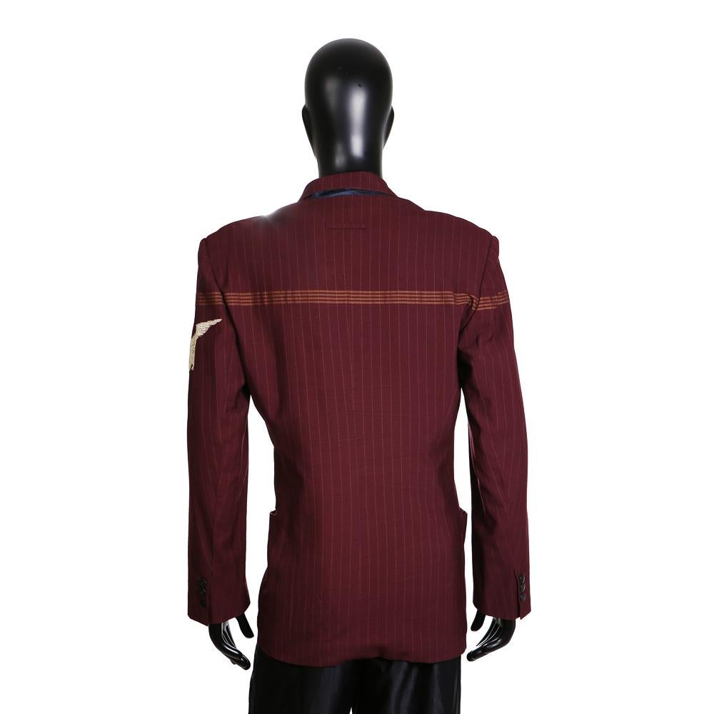 Men's jacket by Jean Paul Gaultier
Military inspired details such as eagle icon on left upper arm
Double breasted
Burgundy wool with rust pinstriping
Condition: Excellent

Size/Measurements:
Size 50 (EU)
22