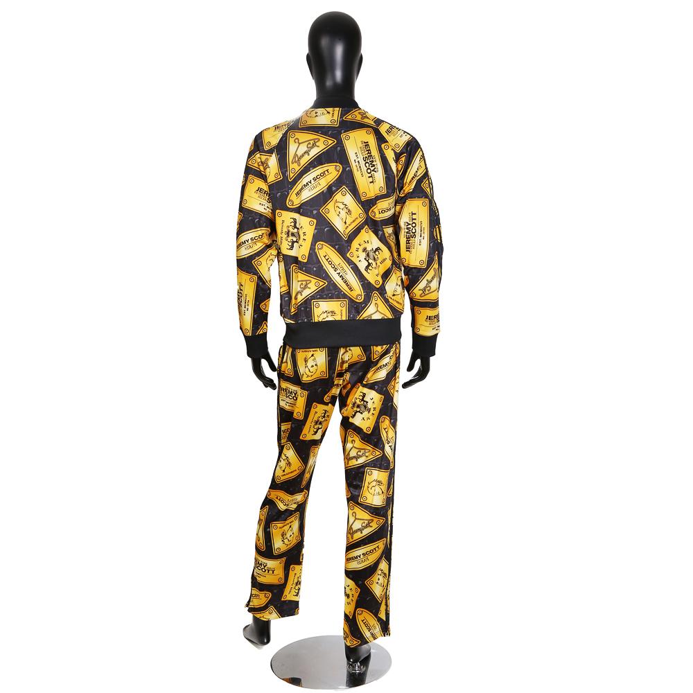 Men's track suit by Jeremy Scott (in collaboration with Adidas)
Gold plaques print all over
Black Adidas triple stripes down sides of both pieces
Condition: Excellent

Size/Measurements:
Size large
22