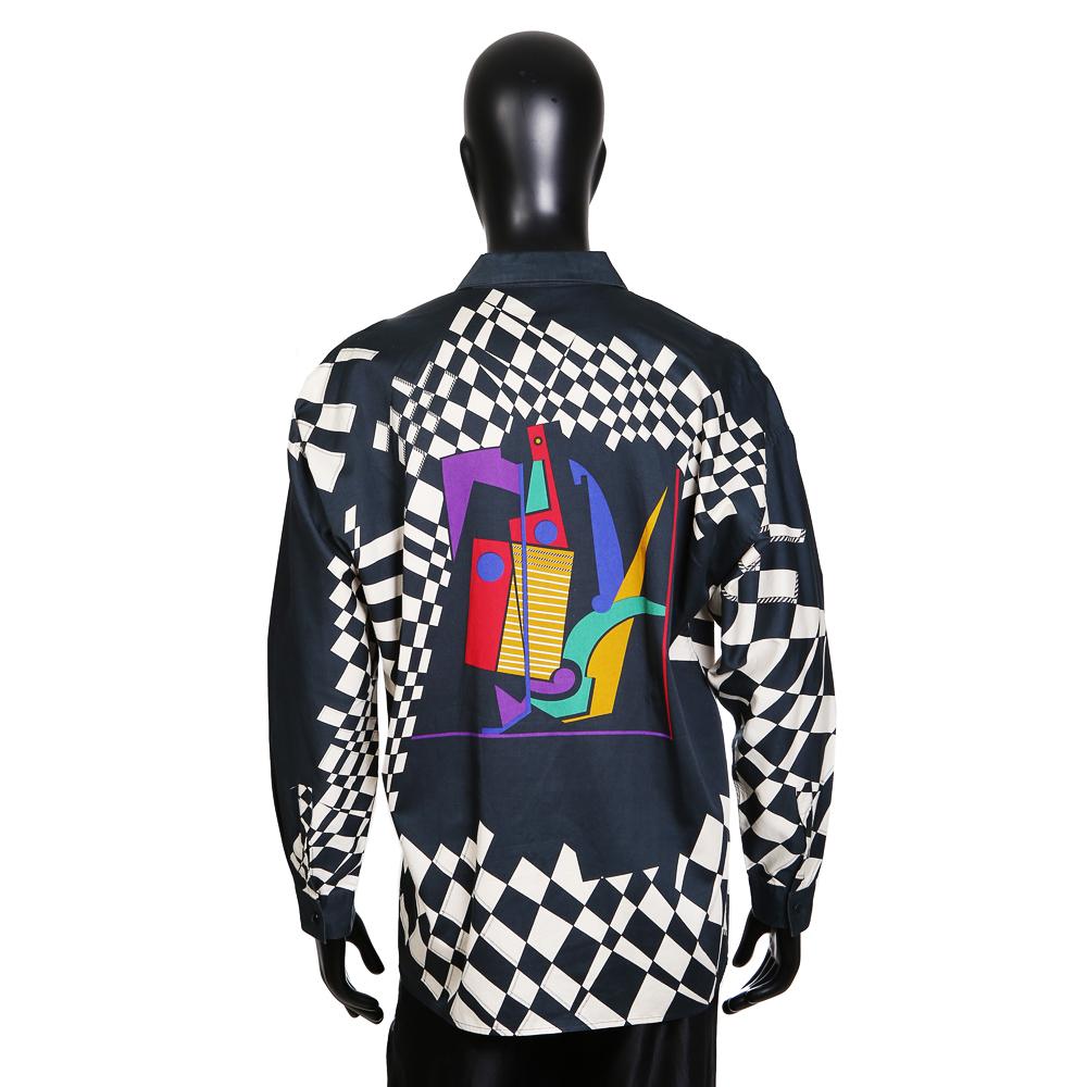 Men's cotton shirt by Gianni Versace circa 1980s
Features wrapped black and white checkered print with multicolor print in the middle of the chest
Hidden front button closure

Condition: Excellent, just missing bottom button
Size/Measurements:
25