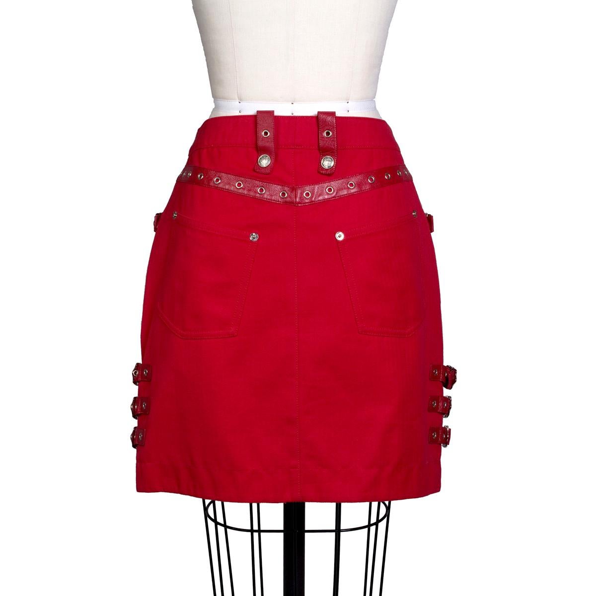 Skirt by John Galliano for Christian Dior, circa 2000s
Red cotton with red leather trim details
Also has grommets, buckles, and cinch details
Condition: Excellent

Size/Measurements:
Size 8
29