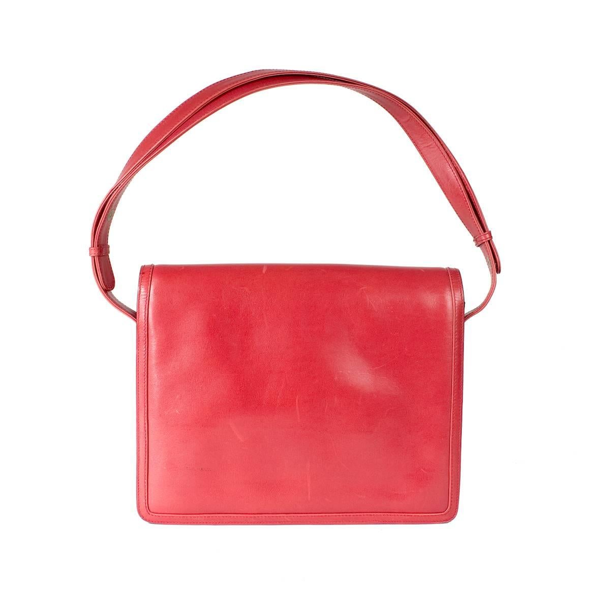 This is a vintage shoulder bag from Gucci. Features red leather with gold hardware, flap closure, and snaps on straps to do a short or long length for the shoulder strap.

Dimensions:  10" x 1.75" x 8.5"