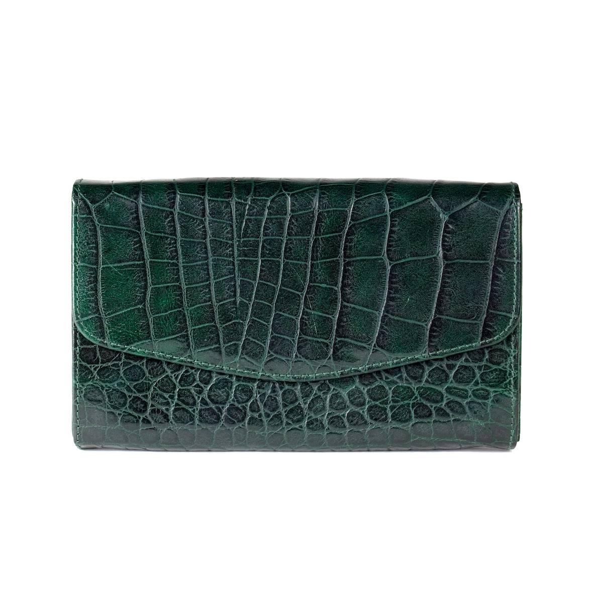 This is a wallet from Sonya Rykiel.  It features a dark green faux croc embossed print.  Flap closures with snap.  

Wallet dimensions:  7.5" x 1.25" x 5"

