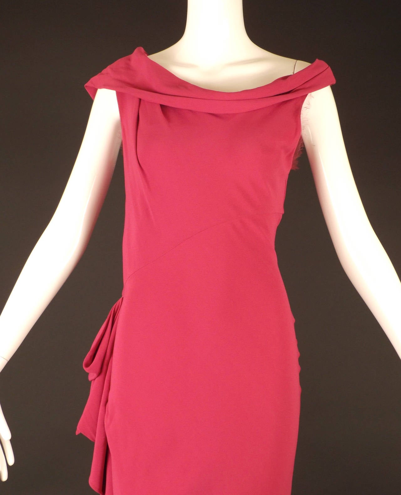 Elegant 1930s style, bias cut evening gown in a hot pink silk crepe. The gown has a bias bodice with a draped, cowl neckline that falls in pleats from the left shoulder and circles the neck with draping over the right arm.  Diagonal cut waist seam