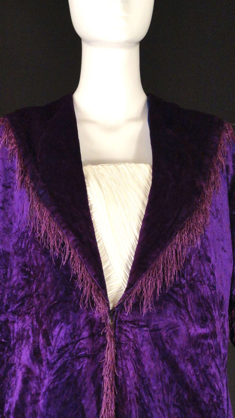 Amazing and rare couture piece from the Maison Doucet dating to c.1912. The coat is a pane velvet in a gorgeous royal purple and lined in a cobalt blue silk.  Spread collar with points in back. Short, set in sleeves are gathered to narrow bands. 