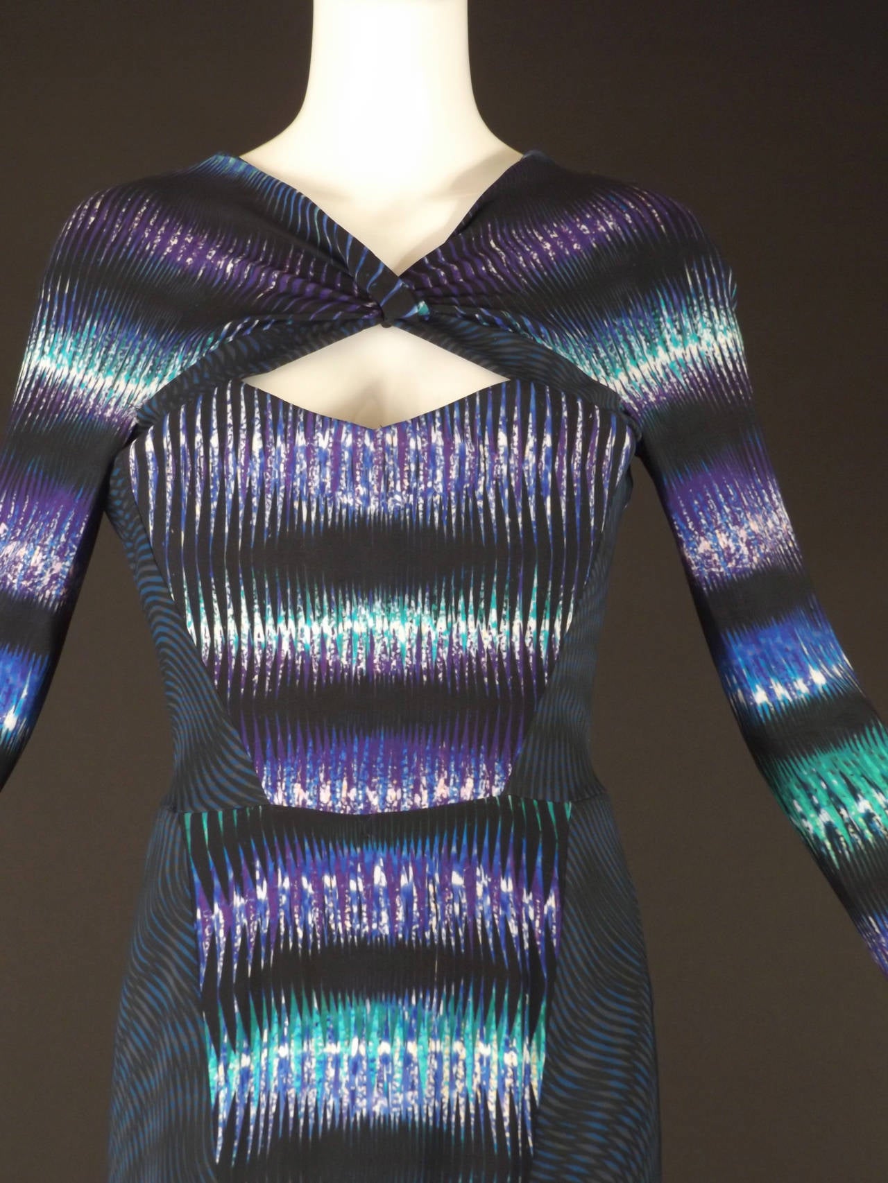 What and awesome piece! The rayon stretch knit gown has two fabrics puzzle pieced together to make one amazing design. One is a zig zag style in green, black, purple and blue. The other is a variegated wavy print in black, blue and gray. The gown