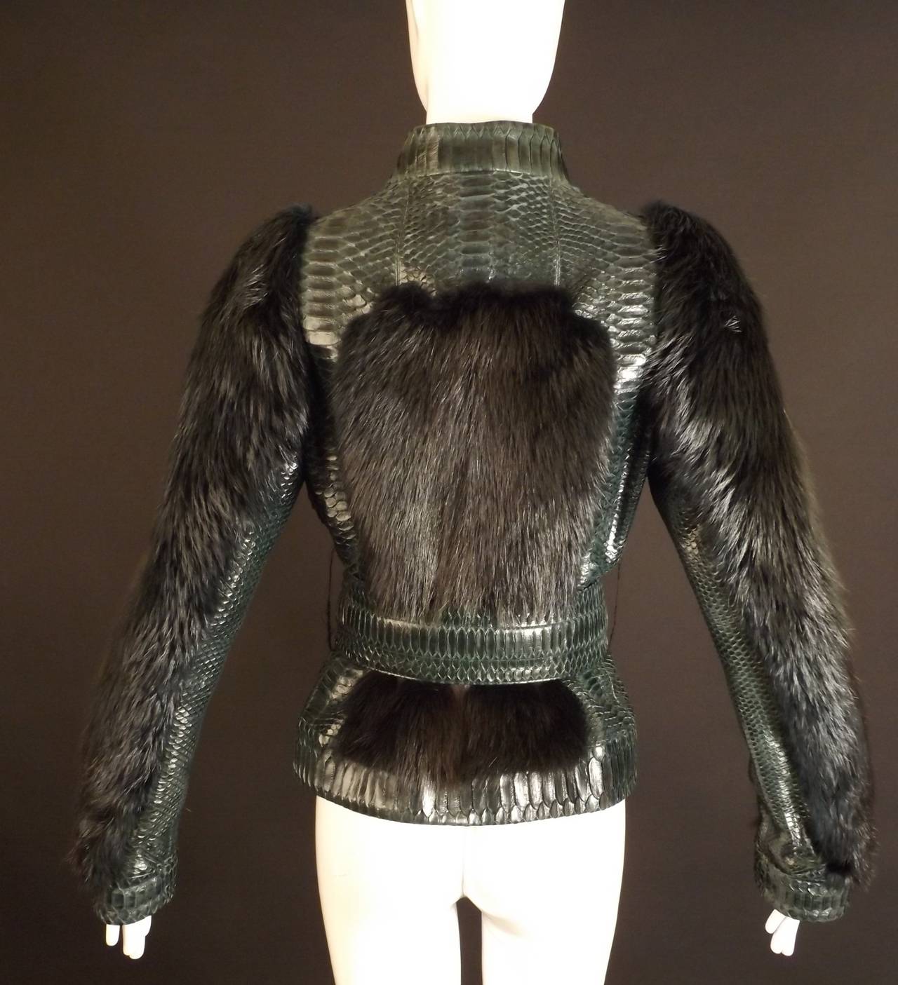 Not sure of the exact date, but I do know it was purchased between 2001-2004 while Tom Ford was designing for Gucci. The jacket is a gorgeous green python with dyed beaver fur. The jacket has a band collar and a hidden zipper closure down the front.
