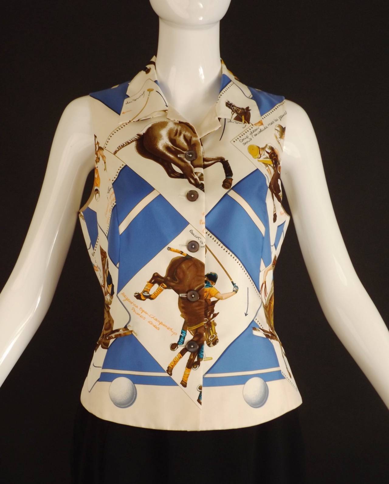 Fabulous silk twill blouse with a polo championship print. The blouse in white with a blue, orange and brown pattern. The blouse has a spread collar and button closures down the front.  Princess seamed though the body with decorative notched pockets