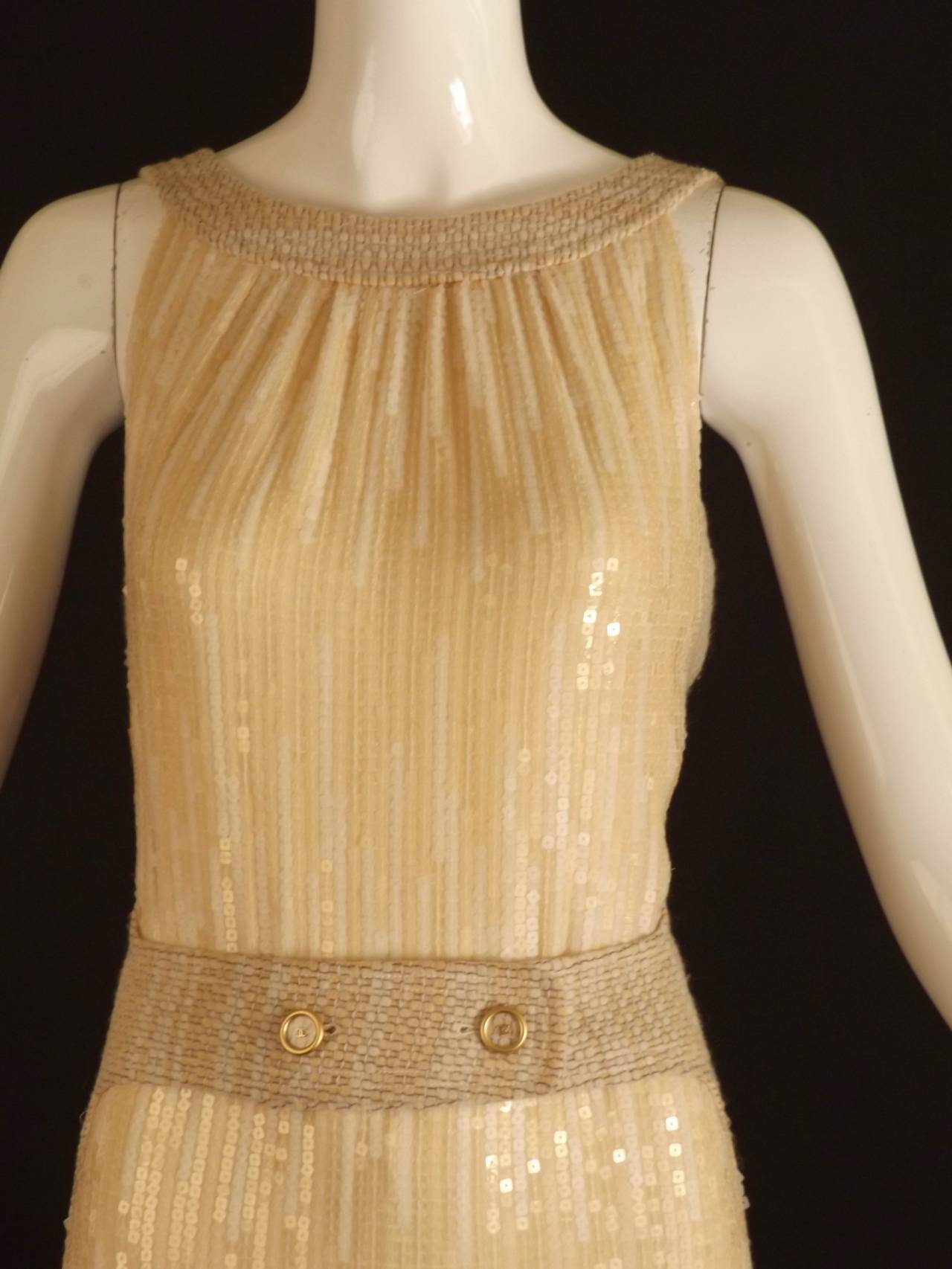 From the Fall, 2001 Runway Collection. The princess seamed gown is a wheat color with the body in two fabrics. The center front panel is a nude silk chiffon covered in nude and clear square sequins. The remainder of the dress is a fabulous wool and