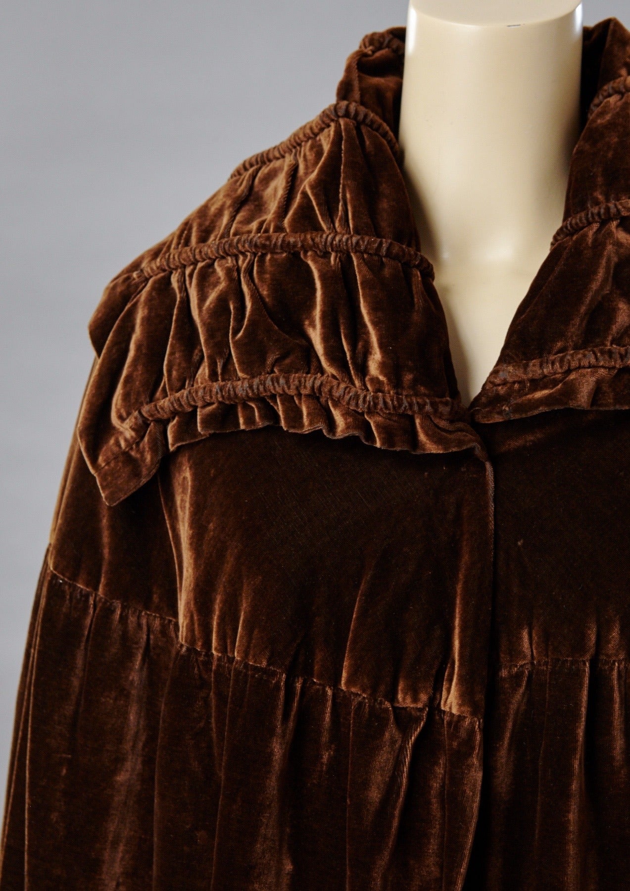 Summer, 1928 Haute Couture, Jeanne Paquin velvet evening cape lined in gold lamé. The collar is rolled and pleated and is about 9 inches wide. The body of the cape fits close to the shoulders. The fullness of the lower cape is gathered into the