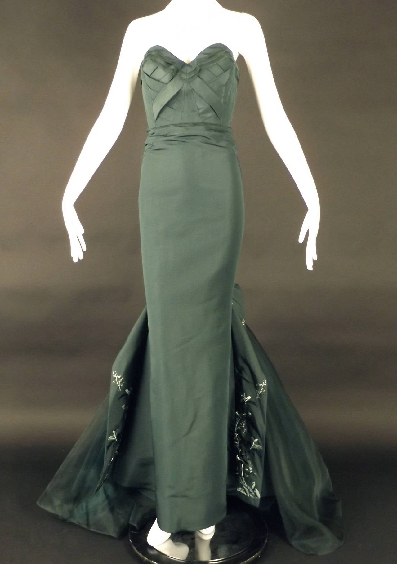 Stunning ball gown from the Fall, 2012 RTW collection. The gown is new with original Neiman Marcus tags still attached at a price of $8,990.00.  The silk faille, forest green gown has an incredible, dart fitted and architecturally designed bodice.
