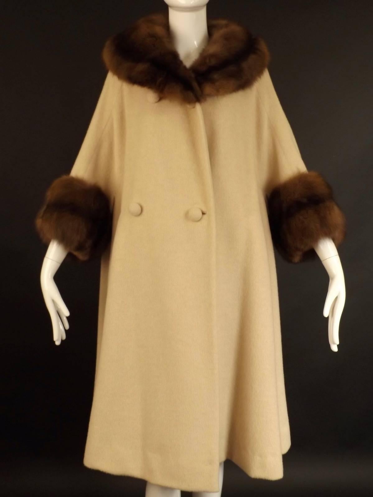 Gorgeous coat from the late 1950s, which if it is, was Designed by Marc Bohan, who left in 1960 to design for Dior. The coat is a plush wool with a wide sable collar and cuffs in mahogany.  The coat is double breasted  down right side and with