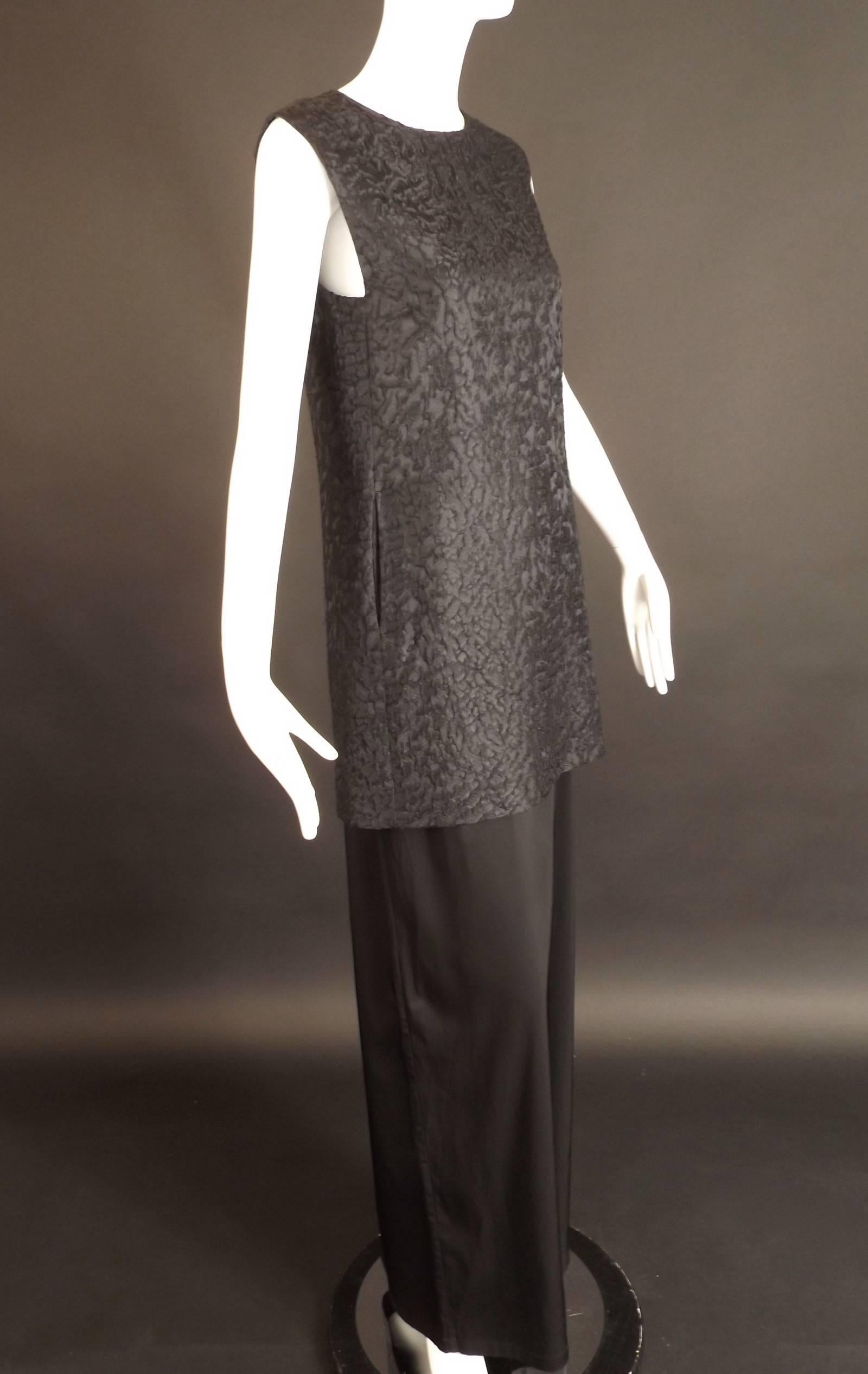 Wonderful Edwardian style evening gown in a black satin brocade and a stretch satin knit. The dress has a tunic upper in the brocade  that has diagonal darts at the bust and a slight a-line shape over the hips. The skirt is attached to a built in