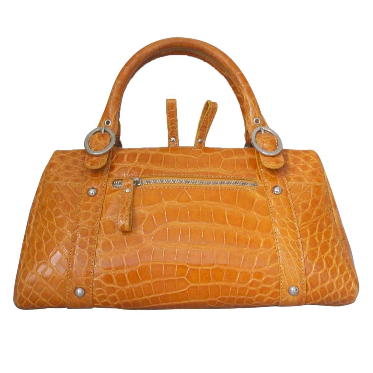Stunning and amazing Colombo Via della Spiga Milano bag
Real crocodile
Ochre color bordering into orange
Two handles
Zip closure
Two external pockets with zip and phone holder
Buckskin internal
Three internal pockets (one with zip)
Cm 32 x