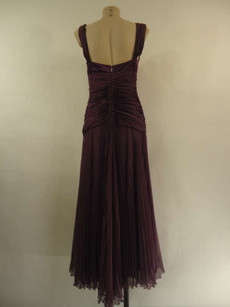 Elegant 2008 Byblos silk evening dress.

100% silk plissé with beautiful work of folds.

Colour purple.

Size 44 (It) - 8 (US)

Made in Italy
New with tags

Fast international shipping included in the price