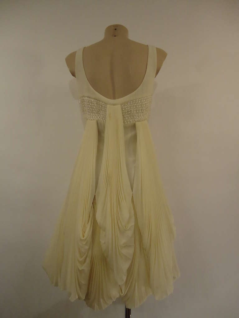 Shining 2008 S/S Byblos silk cocktail dress.
Wonderful work of draperies and embroided silk.

Colour Ivory

100% silk
Made in Italy

Size 42 (It) - 6 (Us)

New with tags

Fast international shipping included in the price