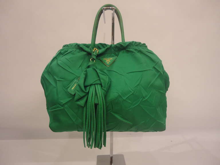 Rare Prada special edition handbag
Green colour

Composition : Embossed textile and leather (soft nappa) 
Handles, fringes and internal closure are in soft nappa.

Inside two zip pockets

Good conditions
Made in Italy

Fast international