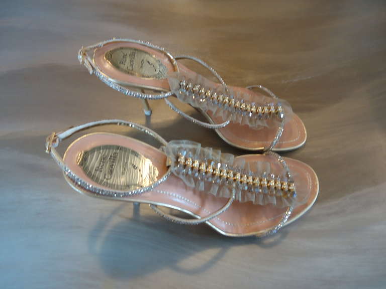 Wonderful René Caovilla jewel sandal

Golden rhinestones and voile
Beautiful design

Three lines of rhinestones
3.9 inches heel

Size 38 1/2 (Italy)

Never worn

Made in Italy
Fast international shipping included in the price