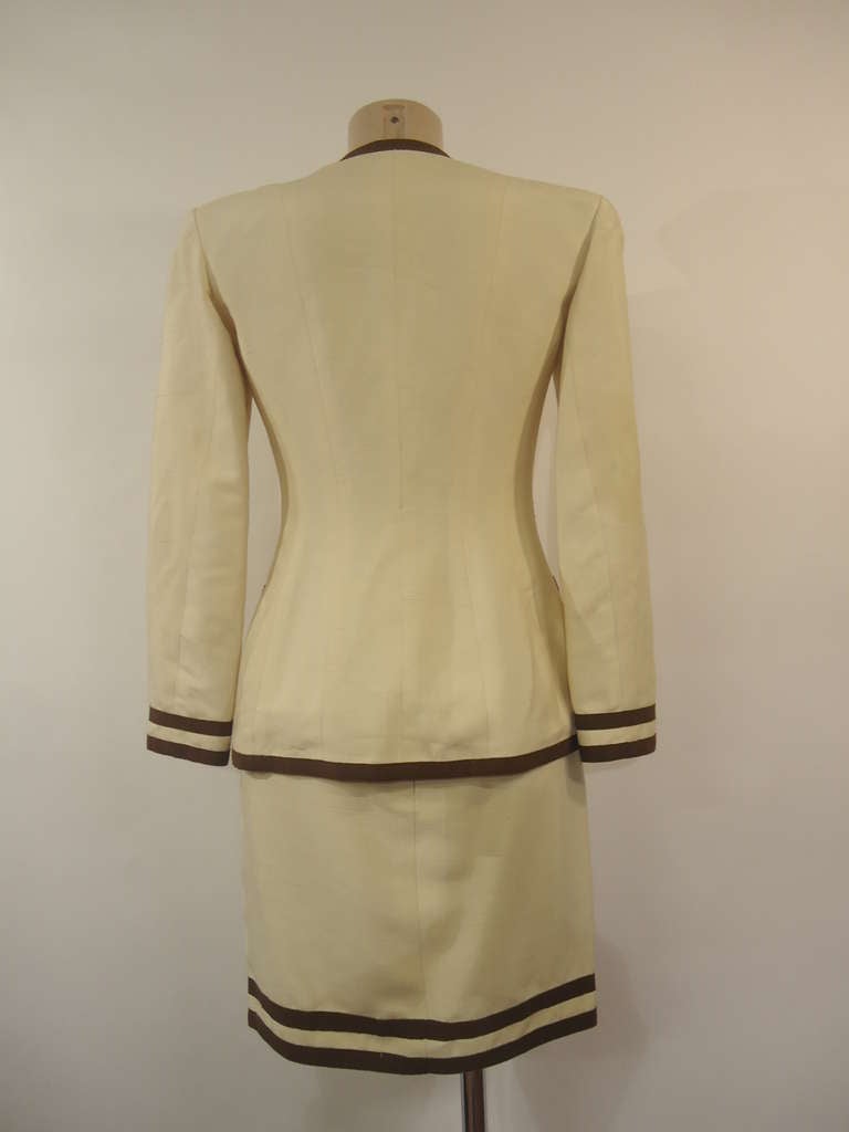 Very elegant Chanel Boutique Skirt Suit

Beige colour with brown stripes contour and buttons

Four parallel pockets

100% cotton
Made in France 
Size 38 (France) - American 8

Very good conditions

Tags of composition have been