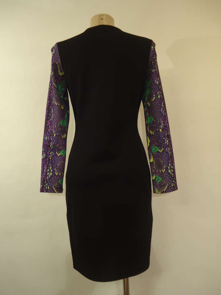 Wonderful dress by Roberto Cavalli
Multicolored printed python on textile

The front of the dress presents a mix of colours like purple, yellow and green while the back is black.

Long sleeves

Materials :   84% viscose, 11% polyamide, 5%