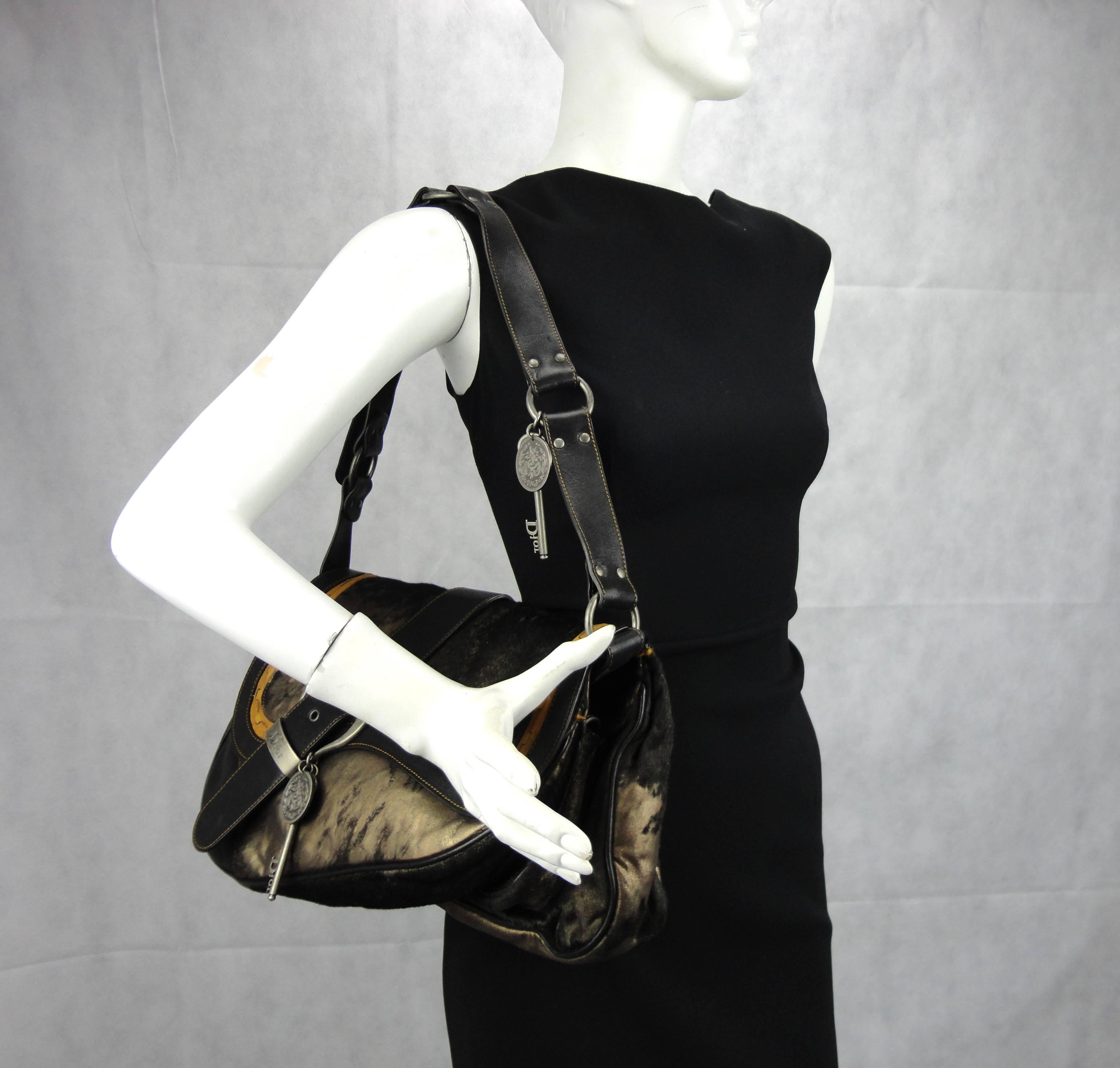 Christian Dior Gaucho double saddle bag in black pony skin with distressed gold leather. The fold over flap gives this bag a true saddle shape, the exterior is clean and beautiful without any signs of wear and the interior is also in mint condition.