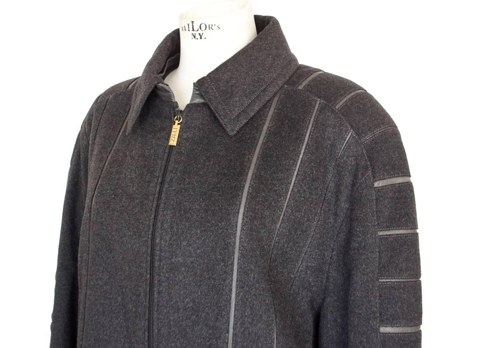 Guaranteed authentic Zilli grey cashmere modified bomber jacket. 
Remarkable workmanship and fabric quality sets this label apart.
Grey leather inset strips highlight the extraordinary workmanship of this piece.
Signature detachable collar reveals