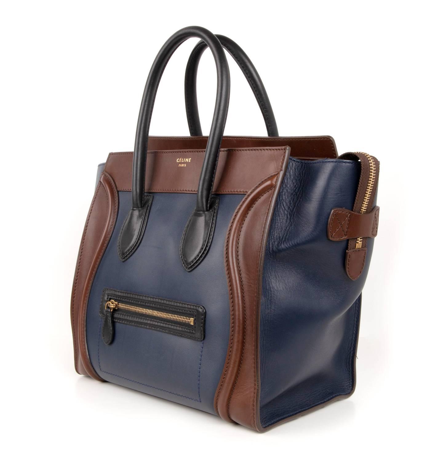 Guaranteed authentic Celine Tri colour medium Phantom luggage tote bag.
An iconic beauty in Navy and Brown with Black front zip and handles. 
Zip top with 2 interior slot pockets and 1 zip pocket. 
1 exterior zip pocket. 
4 metal feet.
CELINE PARIS