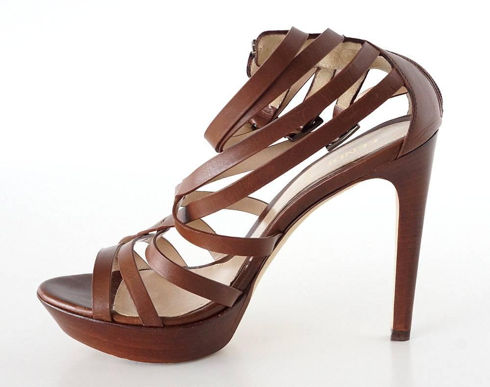 Guaranteed authentic Fendi strappy high cut shoe
Fabulous strappy high heel in a deep cognac color that goes all the way up the ankle.
Top 3 straps have buckles embossed Fendi.
Closed heel with zipper. 
Stacked wood platform and thin shaped heel.