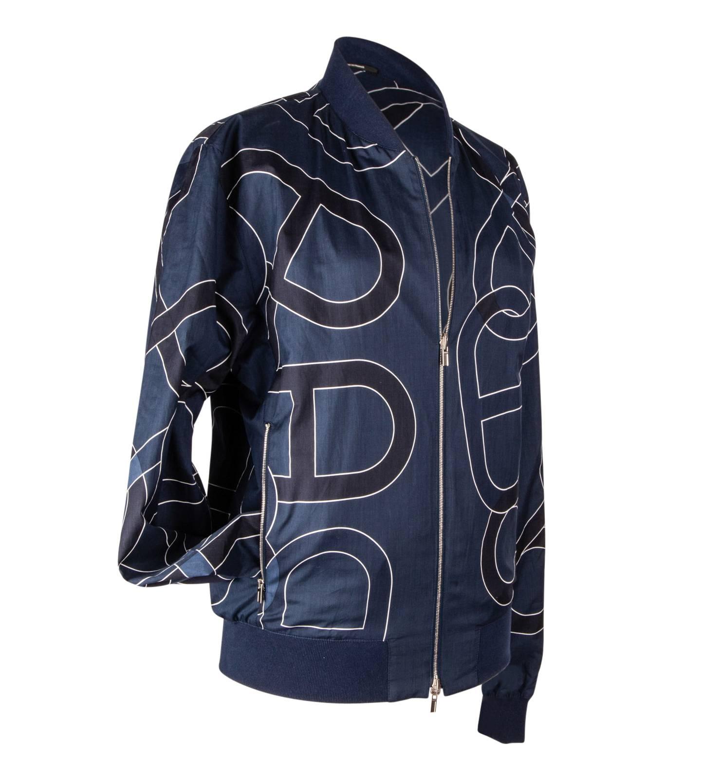 Mightychic offers an Hermes feather light chic reversible men's windbreaker.  
Blue windbreaker reverses to a black and blue Chaine d'Ancre print.
Jacket has zips on both sides with embossed pulls.
Cuffs, waistband and collar are knit. 
NEW or NEVER