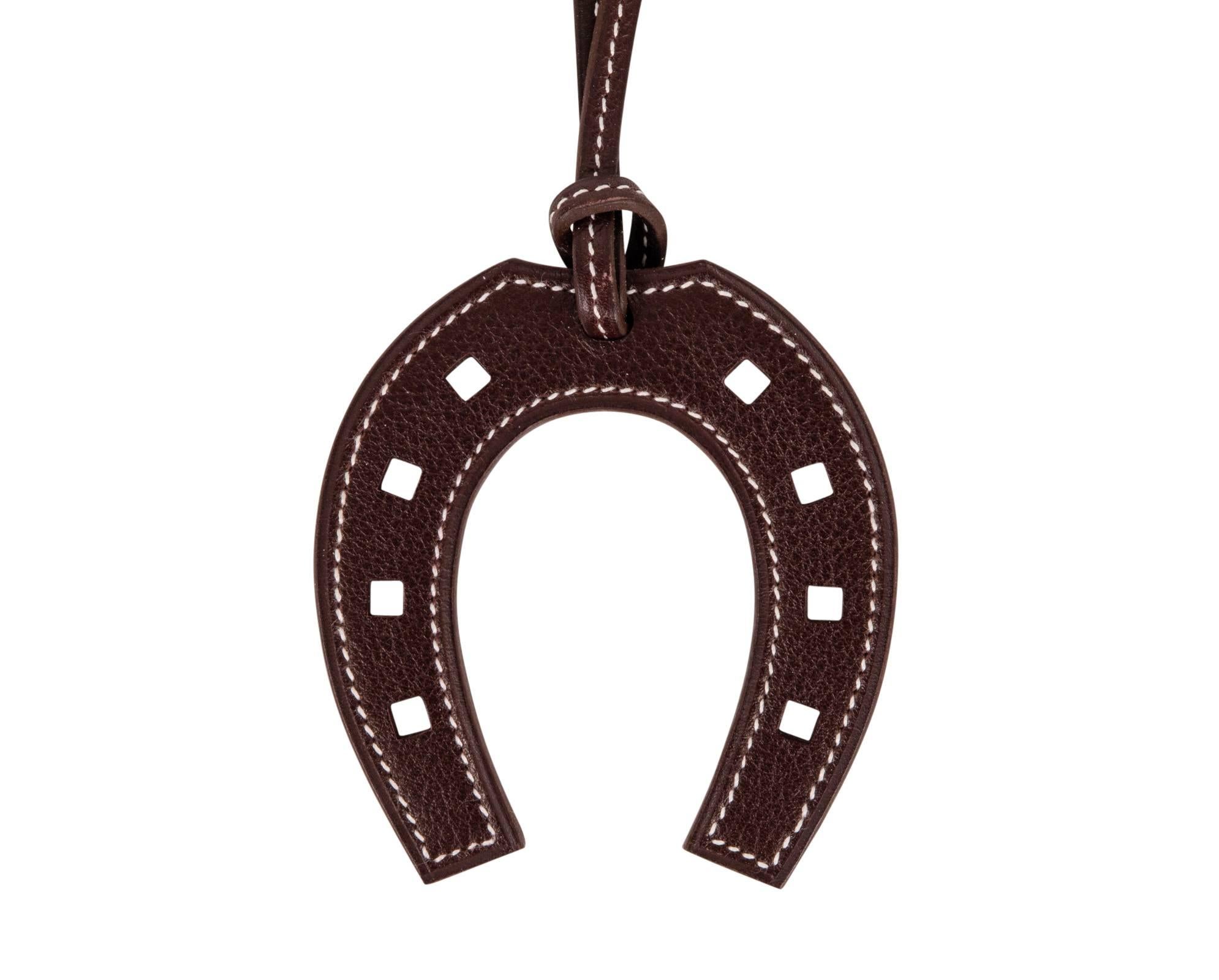 Guaranteed authentic Hermes Paddock Fer A Cheval Horseshoe bag charm in rich dark brown. 
Stamped HERMES PARIS MADE IN FRANCE.  
NEW or NEVER WORN.
Comes with signature Hermes box
  
CHARM MEASURES:
LENGTH 2.75