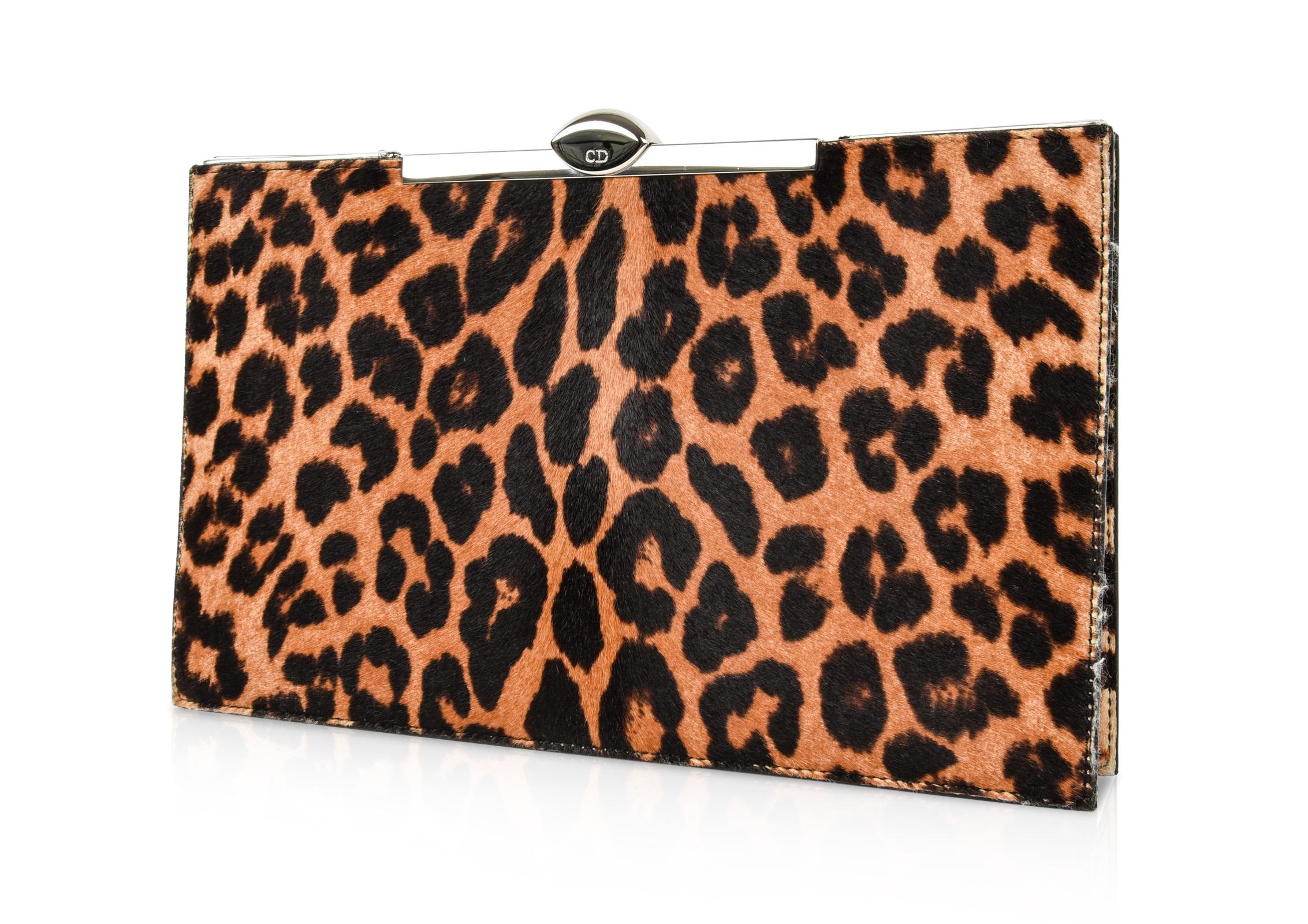 Guaranteed authentic Christian Dior leopard print pony clutch frame bag with silver toned hardware.
Slim and sophisticated with unique opening.
Top closure is domed with CD embossed.  
Small interior pocket has silver hardware detail with a mirror