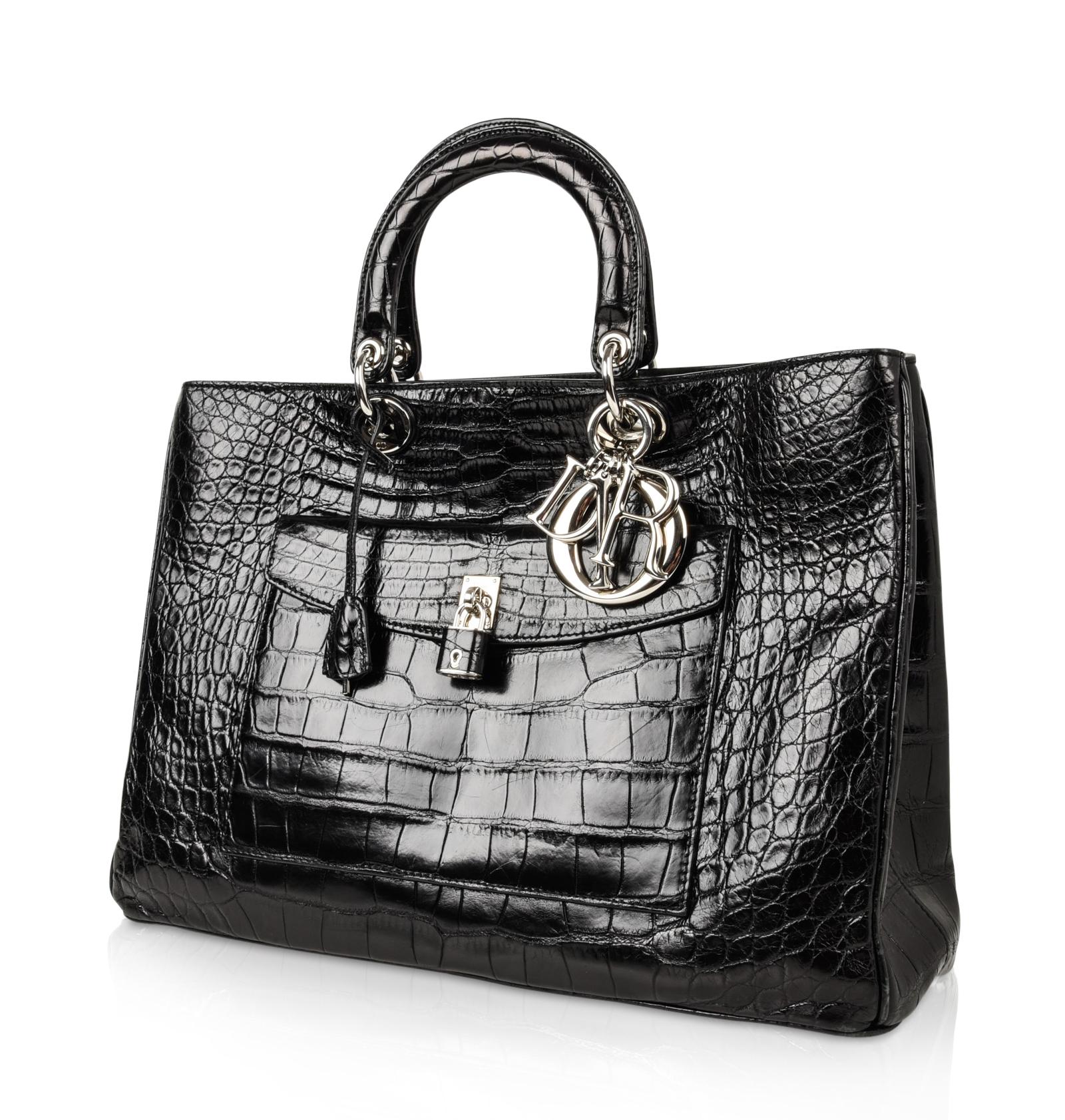 Christian Dior Black Diorissimo Pocket matte crocodile tote bag with silver toned hardware.
In crocodile this rare beauty was only available in France and New York.
Exterior front pocket with turn key and embossed logo.
Signature silver logo