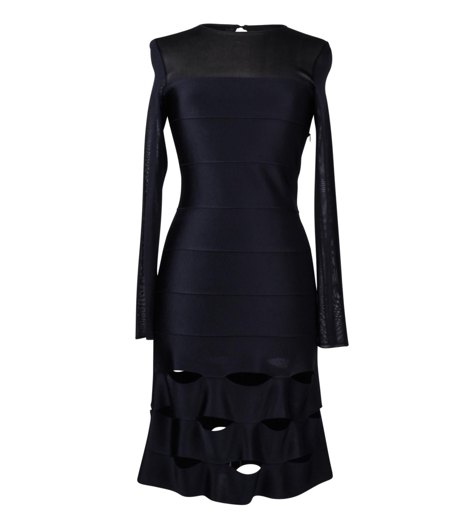 Guaranteed authentic Christian Dior mesh and bandage black dress. 
Mesh panel extends from bust line to neck.
Lower portion has open bandage strips. 
Long mesh sleeves.    
Comes with detachable black translucent slip.
Fabric is viscose and lycra 