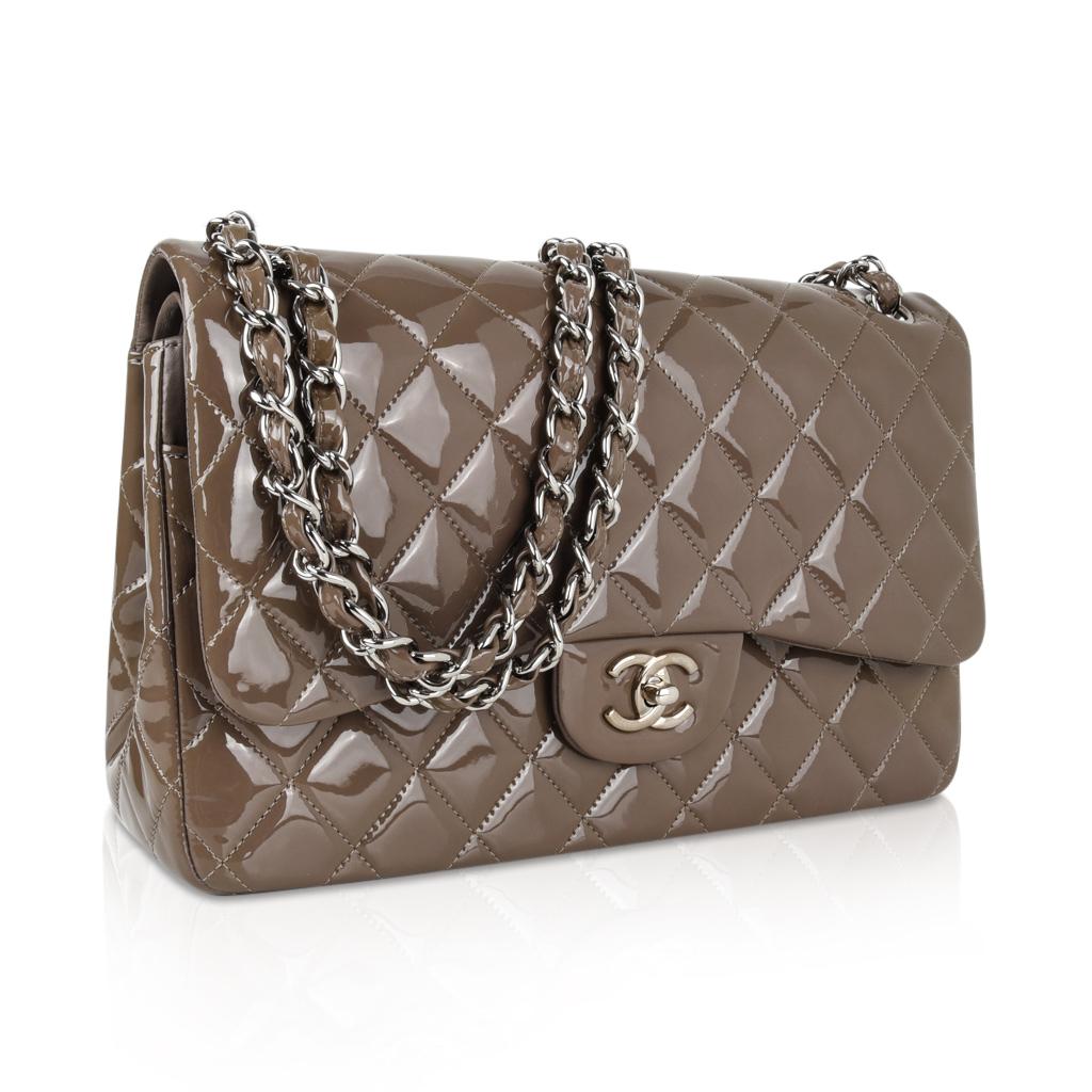 Guaranteed authentic Chanel Jumbo Classic Double Flap bag in rich taupe quilted patent leather with silver toned hardware.
Signature CC Mademoiselle turn lock.
Opens to a hidden front slot pocket underneath the second flap. 
Interior is lined in