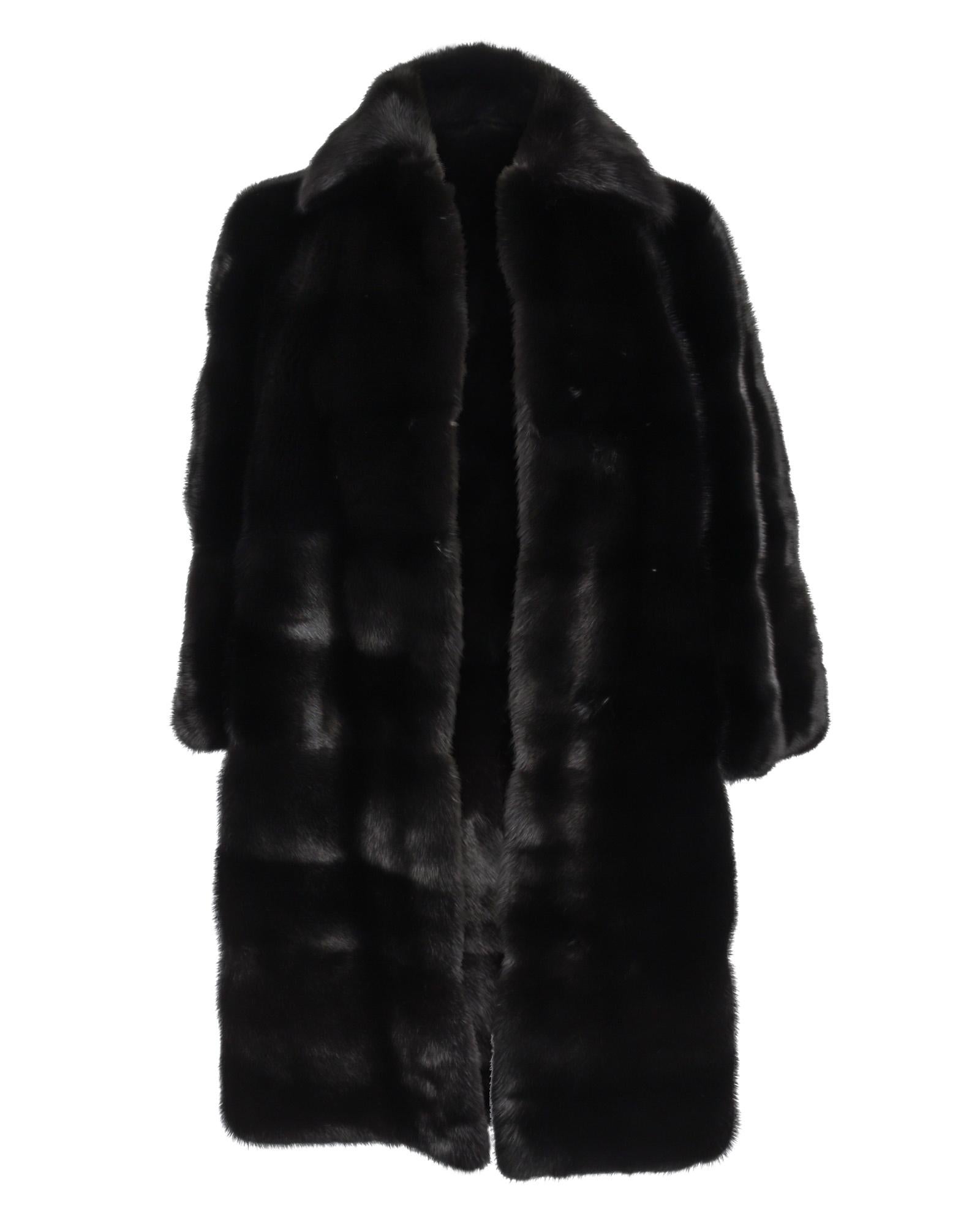 Extraordinary Gucci Black knee length (mid length) mink coat features a straight cut with modern 3/4 sleeves.
This rich glossy sophisticated Gucci fur coat is timeless and will always make a statement in every room you enter.
Classic collar with 4