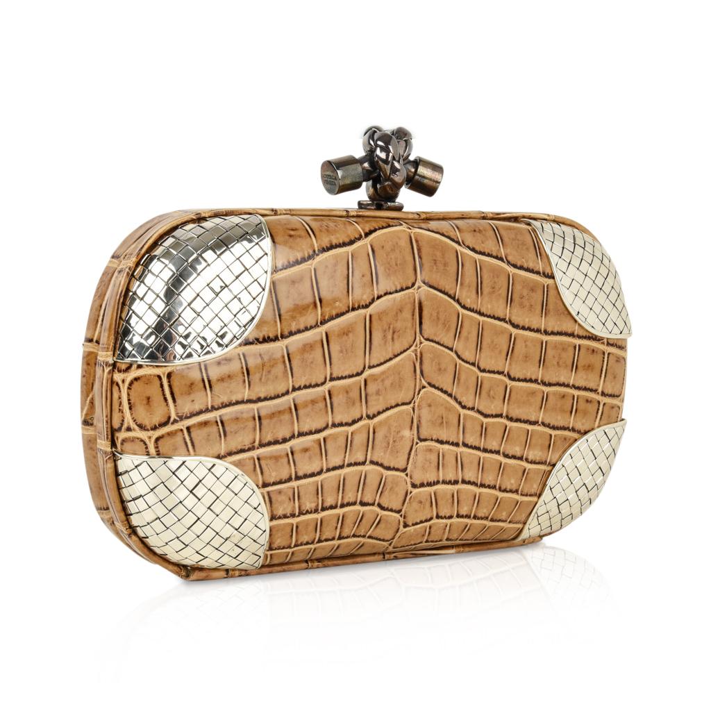 Guaranteed authentic Bottega Veneta iconic Knot Clutch bag in warmed honey tan with
signature silver woven corners.
Rare to find with the metal woven detail.
Soft skin in a framed body with knotted clasp for closure.
Lined in soft suede with