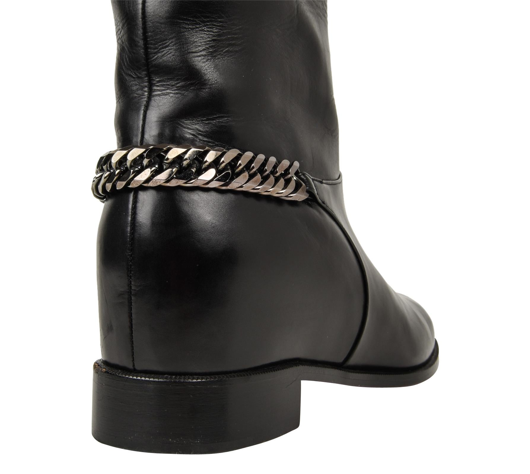 Guaranteed authentic Christian Louboutin flat black leather knee high cate boots.
Boot has hematite colored chain around heel.
Riding inspired.
final sale

BOOT SIZE:  39
USA SIZE  9

BOOT MEASURES: 
HEEL  1