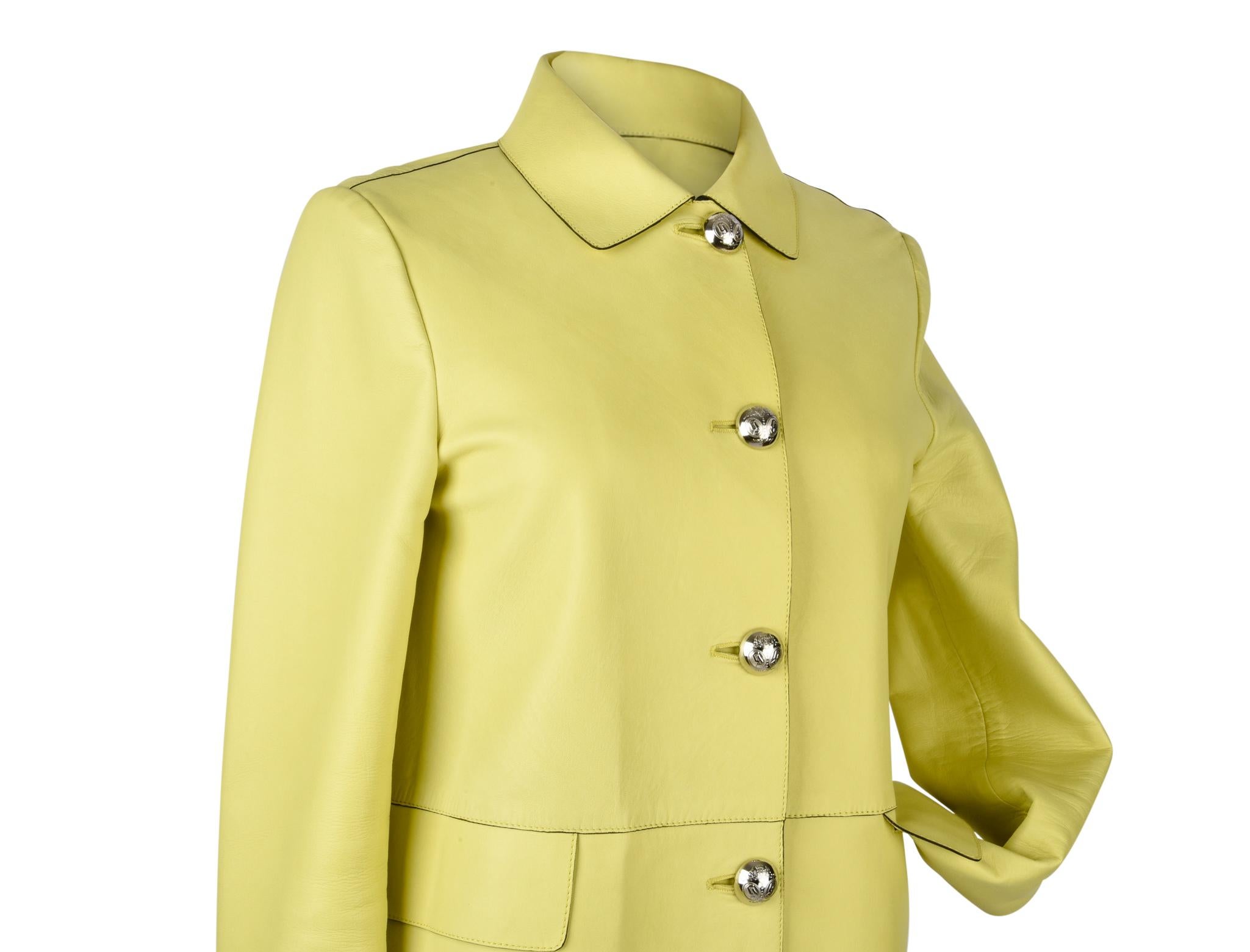 Guaranteed authentic Gucci yellow lambskin coat.  
Knee length and exquisitely soft.
5 silver embossed buttons and 2 flap pockets.
3 working buttons at cuffs.
Coat is not lined.
Fabric is lambskin.
Very light minor marks.
final sale          
  