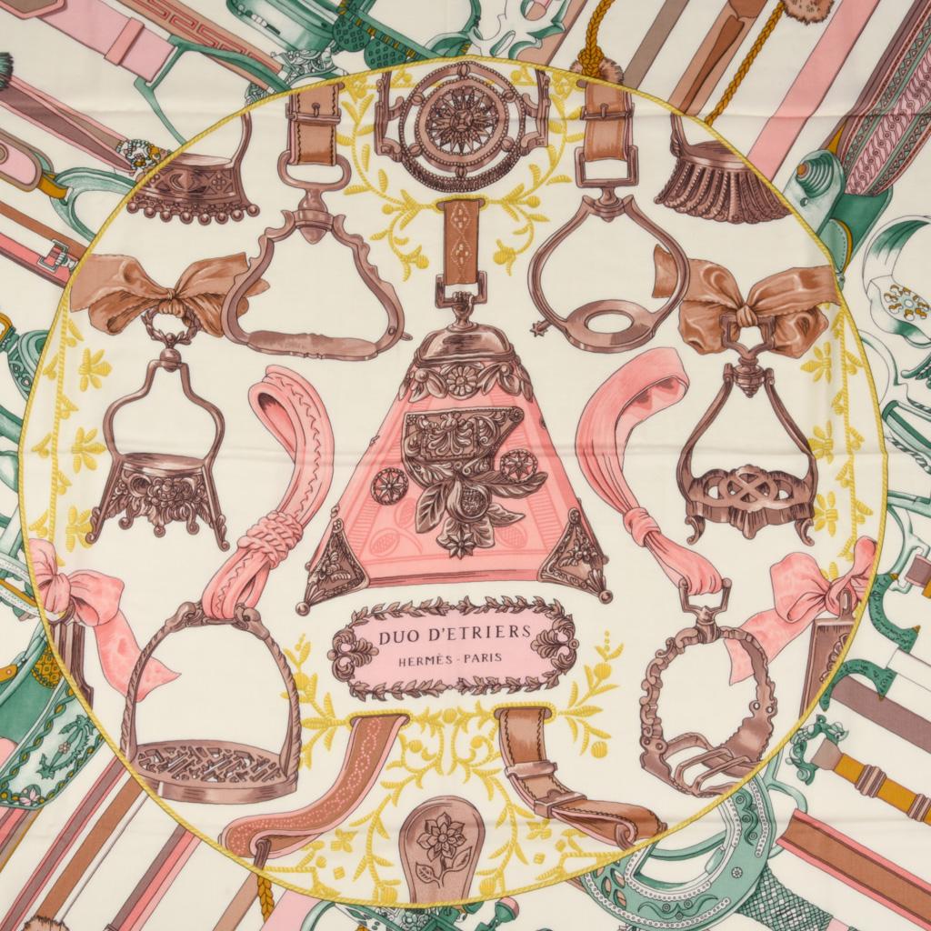 Guaranteed authentic Hermes shawlscarf 70% Cashmere and 30% Silk 140cm Duo d'Etriers print in the coveted pastel colorway of blanc, rose and vert.
Depicting the most beautiful stirrups from around the globe this scarf combines the interpretations of