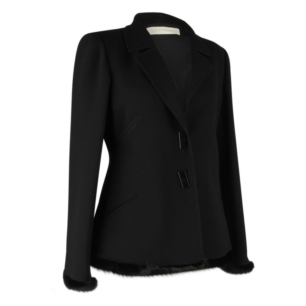 Guaranteed authentic Valentino very beautiful single breast 2 button black jacket. 
Beautifully edged in mink around bottom, cuffs and rear vent.  Trim runs down outer arm.
Buttons are black and rectangular.
Jacket has notched lapels and tonal top