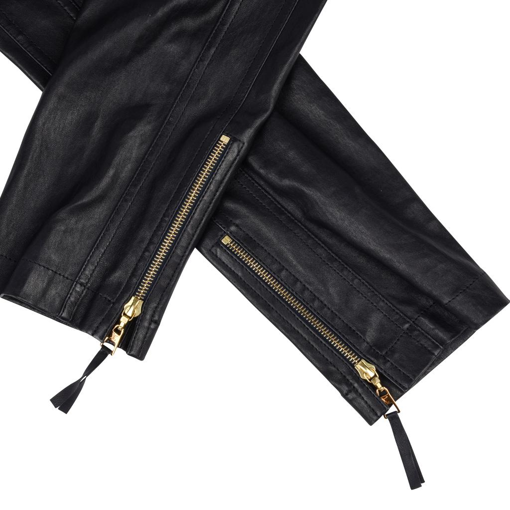 Guaranteed authentic Louis Vuitton black lambskin leather pant.   
Gold ankle zippers with embossed pulls.
Biker / Moto detailing throughout the slim cut pant.
Front zip with hook and eye closure and inside button. 
Waist band has 5 loops.
2 front
